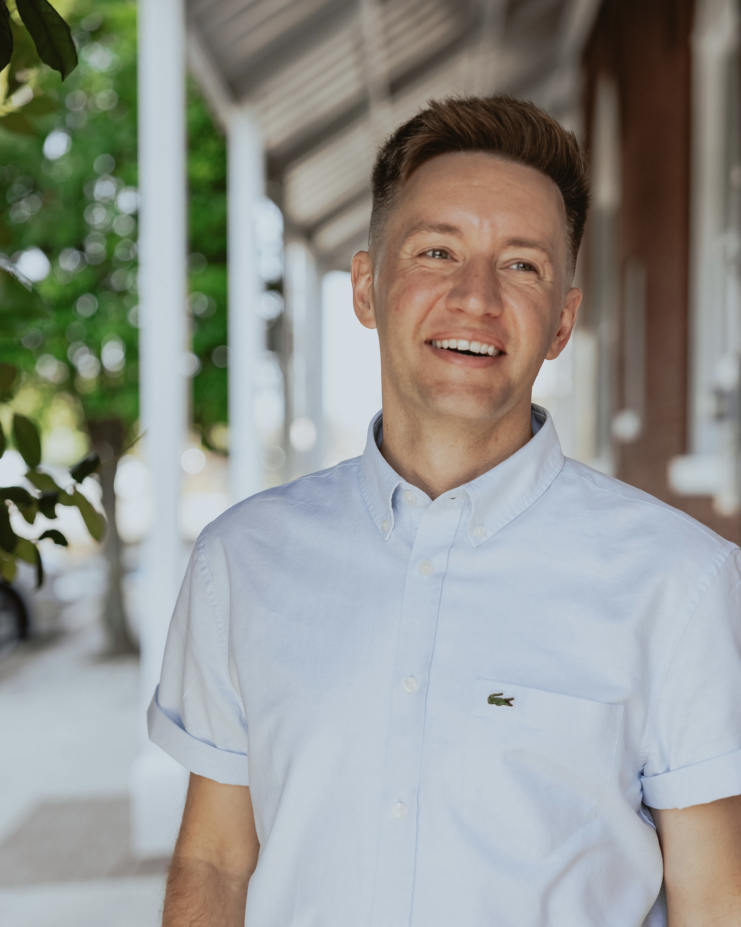 Cody Miller, mortgage loan originator, smiling on a sunny sidewalk